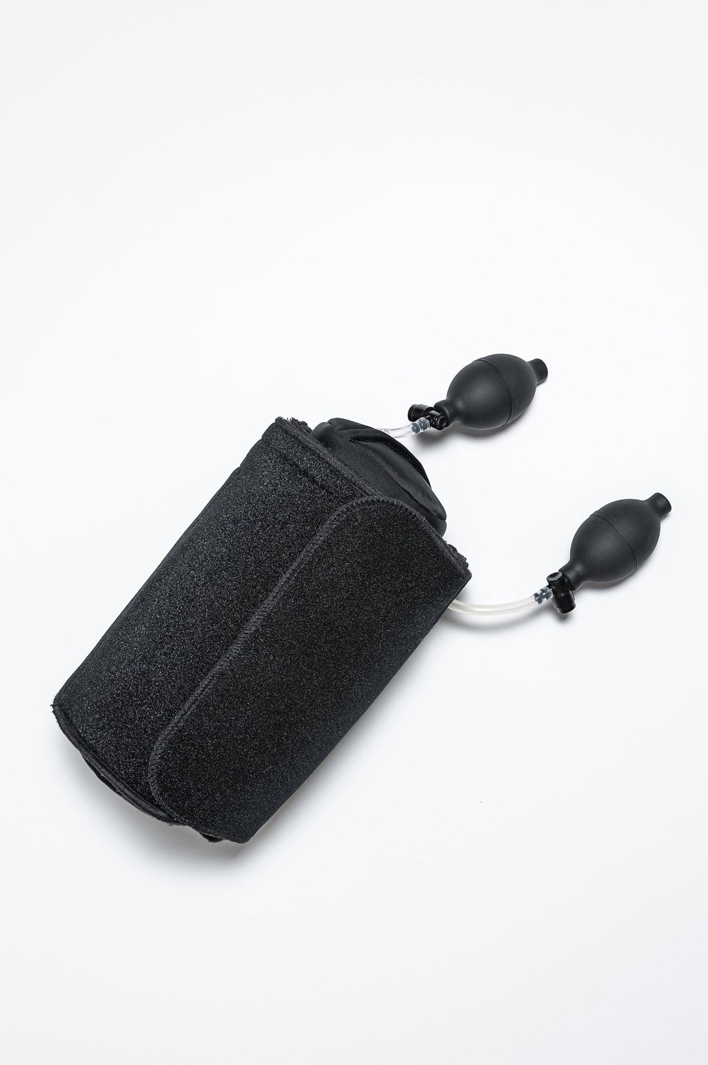 Back Fix lumbar support rolled up in a compact, travel-friendly form with dual pump system visible. Designed for easy portability and convenience.